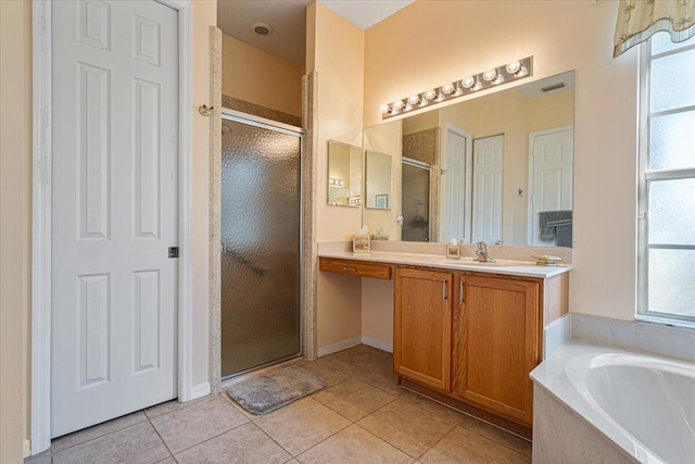 bathroom featuring vanity, tile patterned floors, and shower with separate bathtub