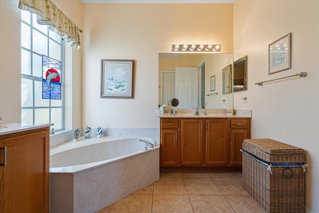 bathroom featuring a bathtub, vanity, and tile patterned flooring