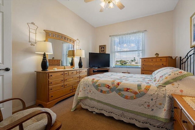 carpeted bedroom with ceiling fan and vaulted ceiling