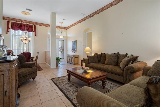 tiled living room featuring a chandelier