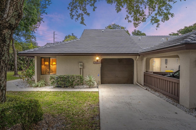 view of front of house with a garage and a lawn