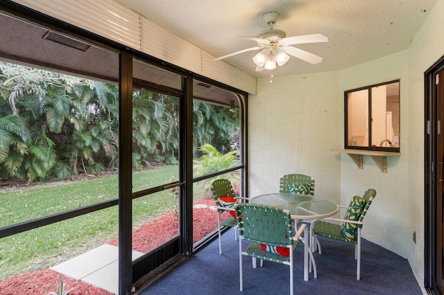 sunroom featuring ceiling fan