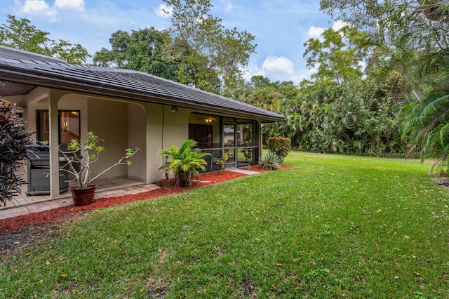 view of yard with a sunroom