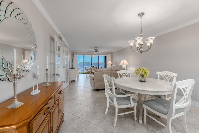 tiled dining space with ceiling fan with notable chandelier and crown molding