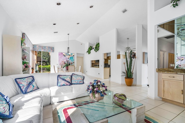 living room with light tile patterned flooring, high vaulted ceiling, and a chandelier