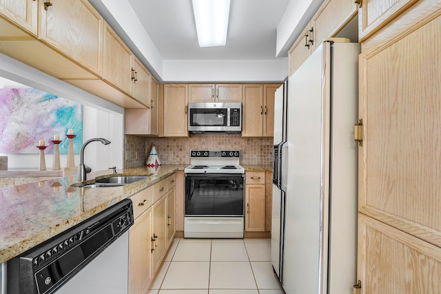 kitchen featuring sink, light tile patterned floors, light stone countertops, light brown cabinets, and white appliances