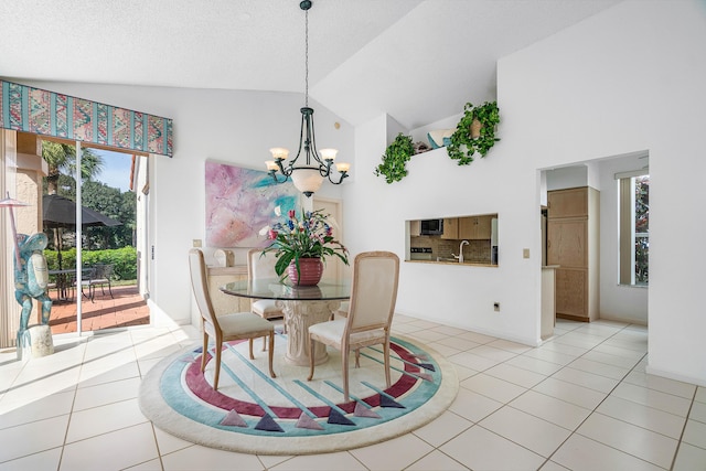 dining space with sink, high vaulted ceiling, a notable chandelier, a textured ceiling, and light tile patterned flooring