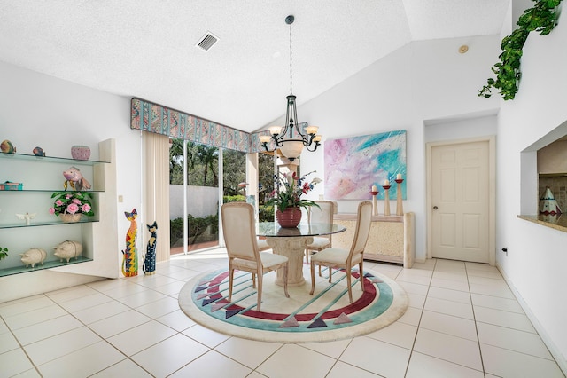 tiled dining space with an inviting chandelier, vaulted ceiling, and a textured ceiling