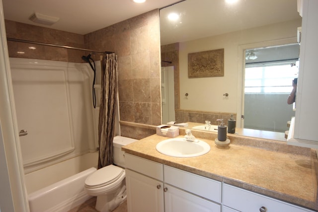 full bathroom featuring vanity, shower / bath combo, and toilet