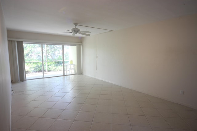 tiled spare room with ceiling fan