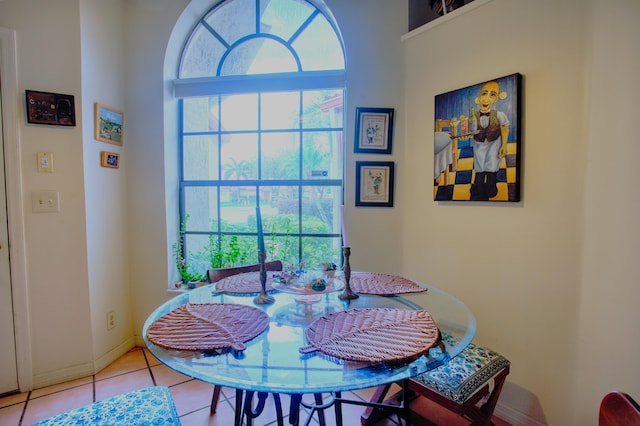 dining space with tile patterned flooring and baseboards