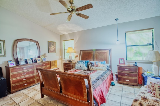 bedroom featuring light tile patterned floors, a textured ceiling, a ceiling fan, and vaulted ceiling