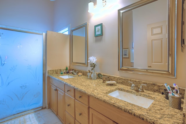 full bath featuring a sink, double vanity, and tile patterned floors