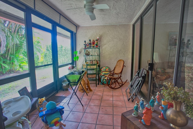 sunroom / solarium featuring ceiling fan
