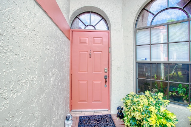 property entrance with stucco siding