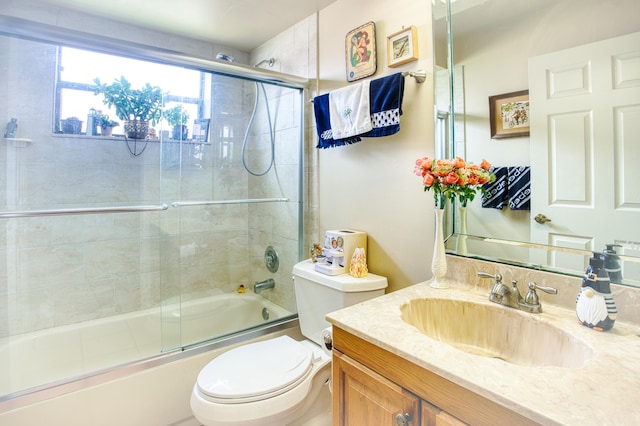 full bathroom with vanity, toilet, and combined bath / shower with glass door