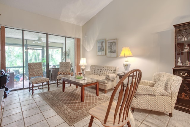 living area featuring high vaulted ceiling and ceiling fan