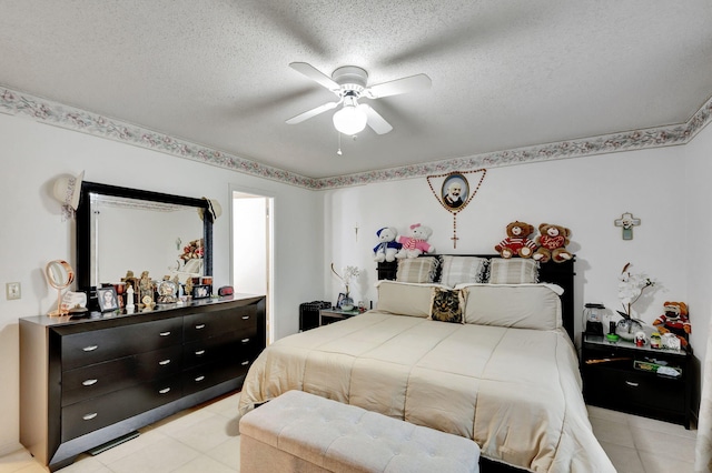 bedroom with ceiling fan and a textured ceiling