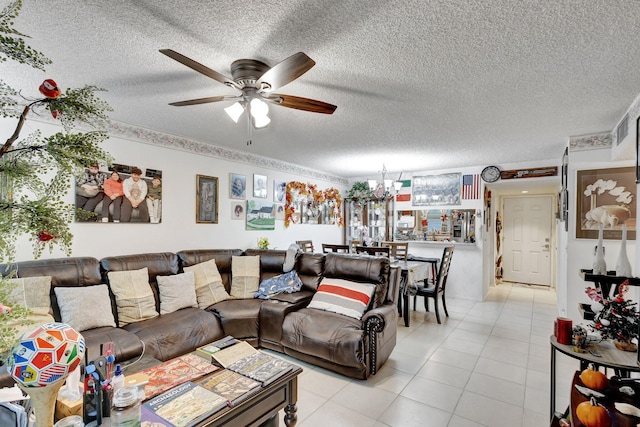 tiled living room with ceiling fan with notable chandelier and a textured ceiling