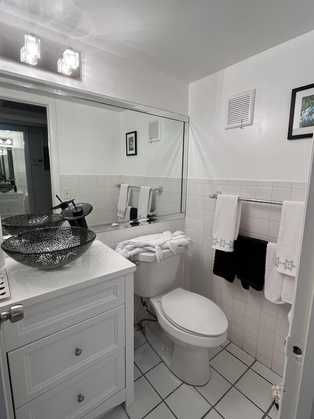 bathroom featuring tile walls, tile patterned floors, vanity, and toilet