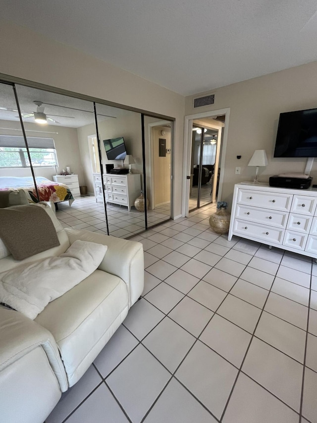 living room with ceiling fan and light tile patterned floors