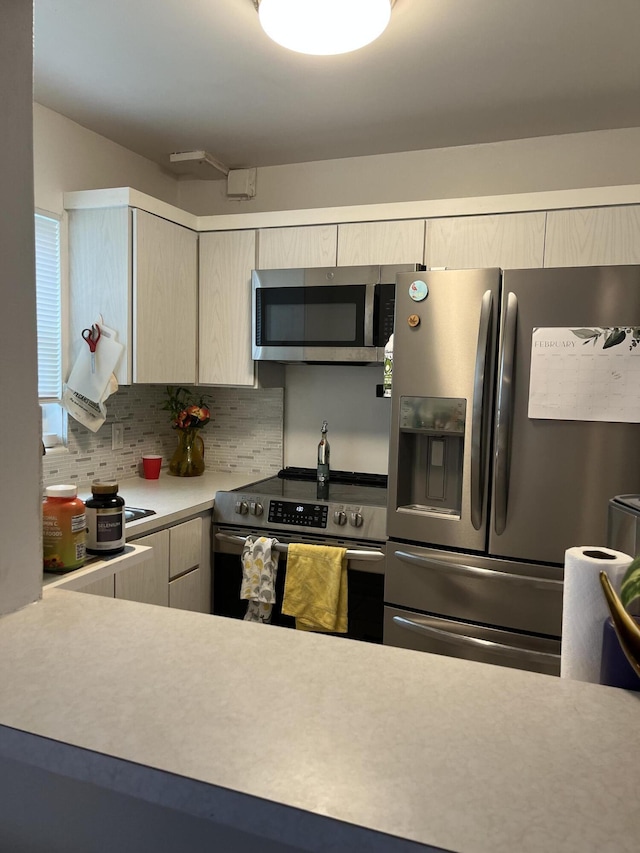 kitchen featuring stainless steel appliances and backsplash