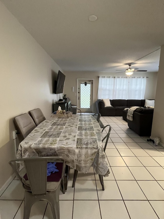 tiled dining area with ceiling fan