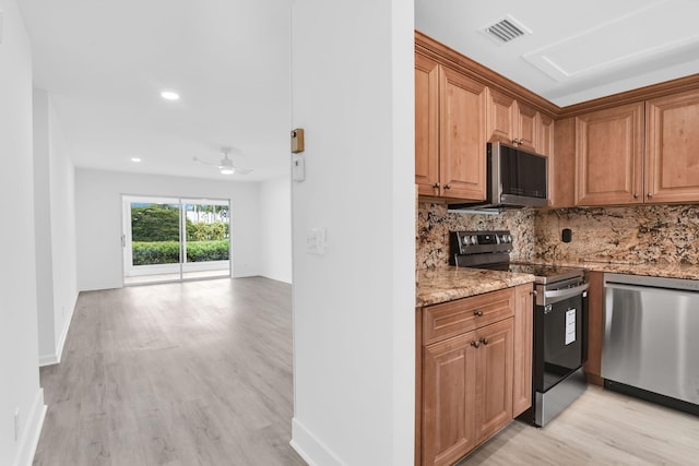 kitchen featuring light hardwood / wood-style floors, stainless steel appliances, ceiling fan, light stone counters, and tasteful backsplash