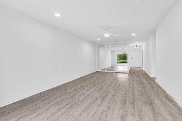 unfurnished living room with light wood-type flooring and ceiling fan