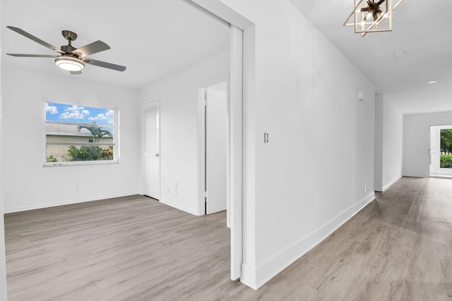 interior space with a notable chandelier, light wood-type flooring, and plenty of natural light