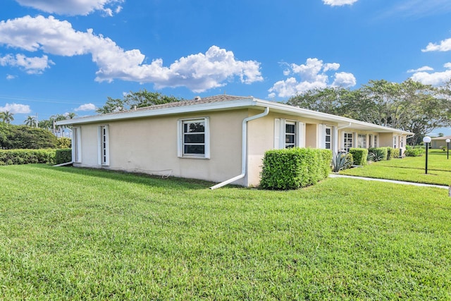 view of property exterior with a yard