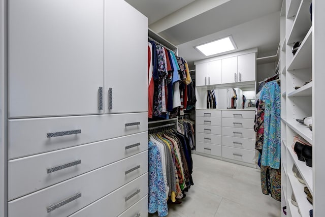 walk in closet with light tile patterned floors