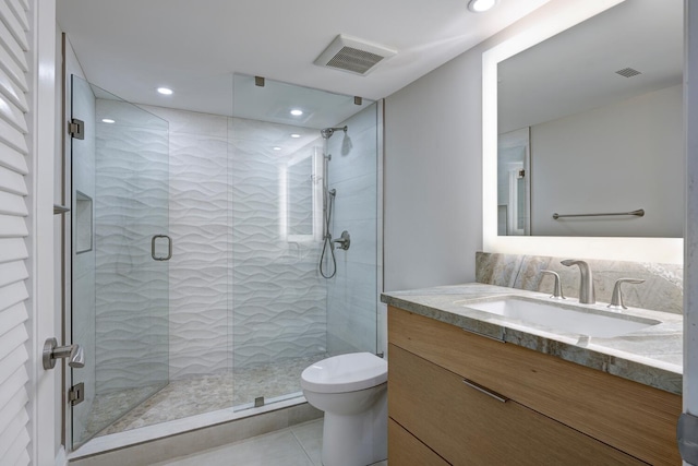 bathroom with a shower with door, toilet, tile patterned flooring, and vanity