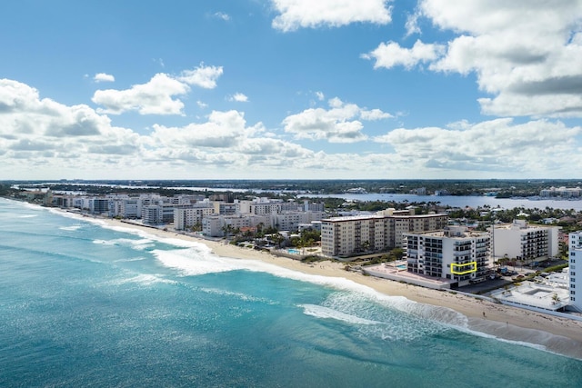 birds eye view of property featuring a water view and a beach view