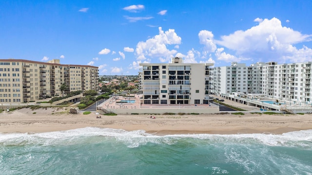 bird's eye view with a water view and a view of the beach