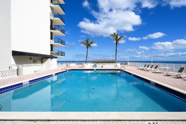 view of pool with a water view