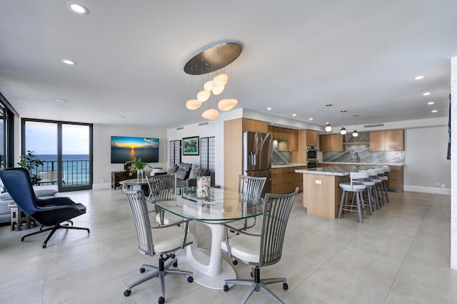 dining area featuring sink and expansive windows