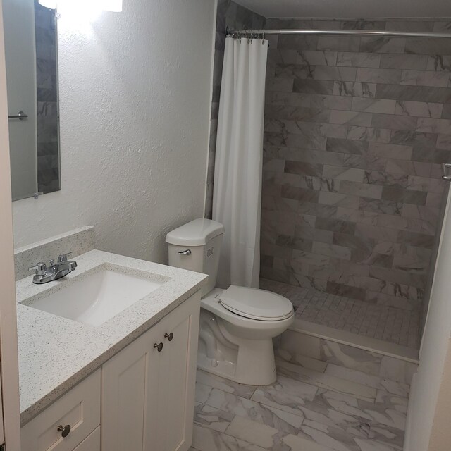 bathroom featuring toilet, tile patterned floors, and vanity