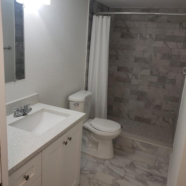 bathroom with toilet, walk in shower, and vanity