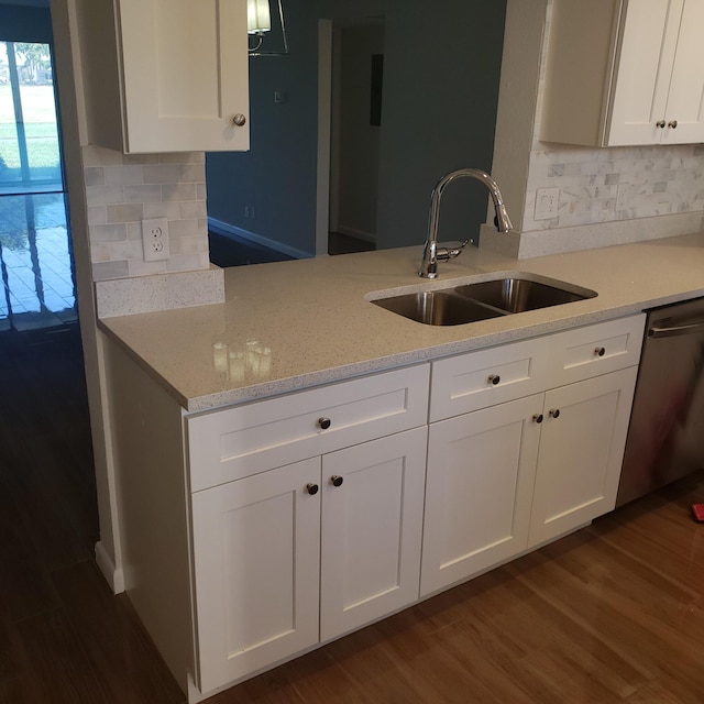 kitchen featuring white cabinets, dishwasher, backsplash, and sink