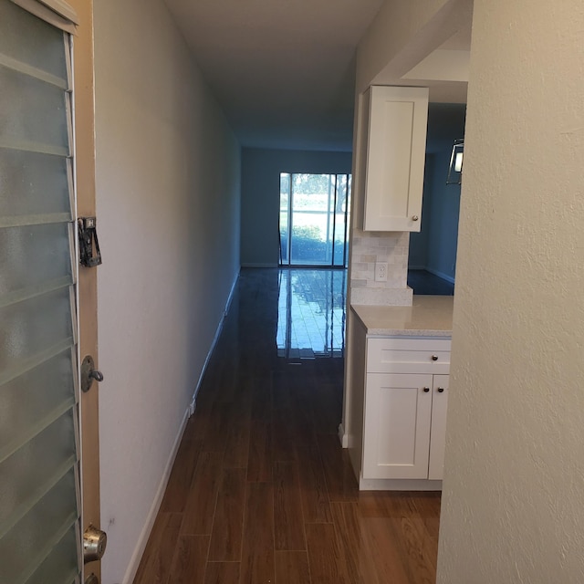 corridor with dark hardwood / wood-style flooring