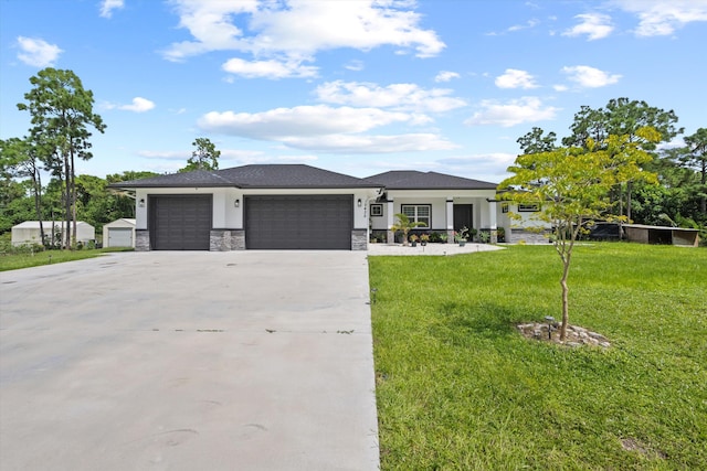 prairie-style home with a front yard and a garage