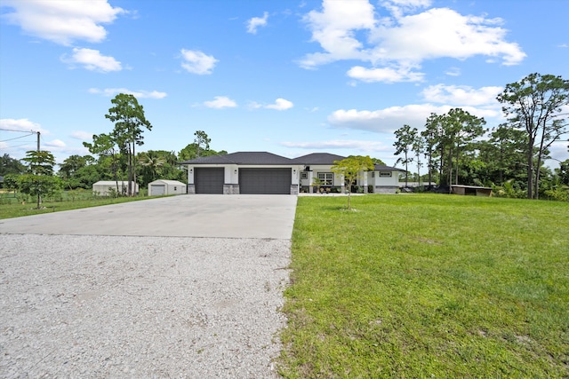 view of front of property featuring a garage and a front lawn