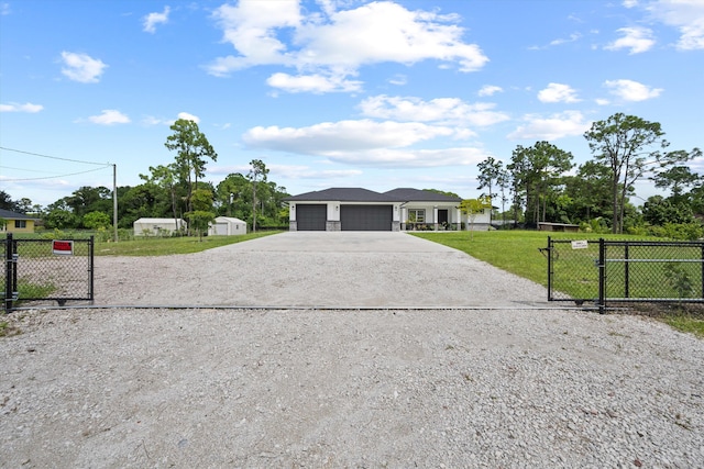 ranch-style home featuring a garage and a front lawn