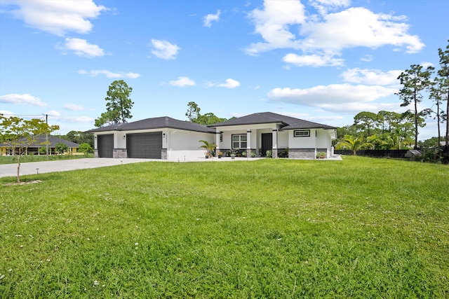 prairie-style house featuring a front lawn and a garage