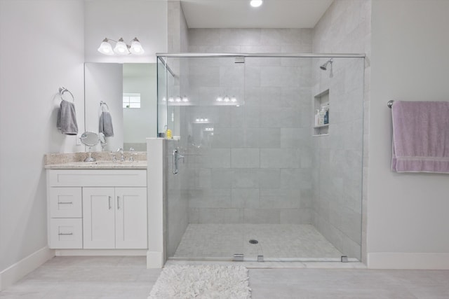 bathroom with vanity, tile patterned floors, and a shower with shower door