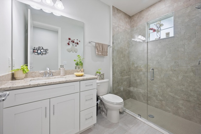 bathroom featuring toilet, vanity, tile patterned floors, and walk in shower