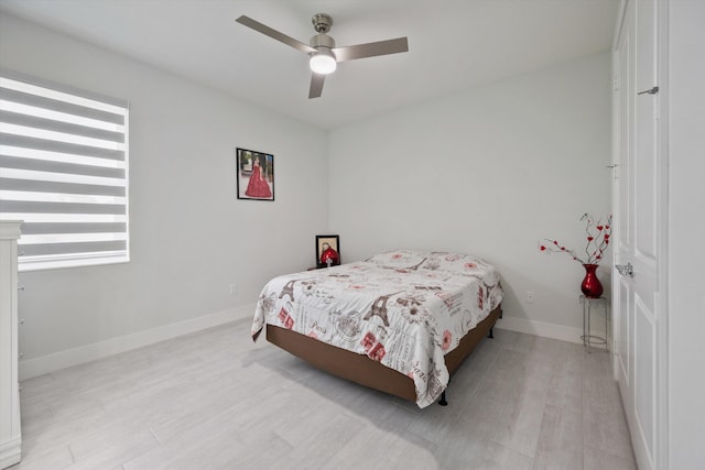 bedroom with light wood-type flooring and ceiling fan