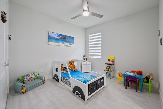 bedroom with ceiling fan and light wood-type flooring