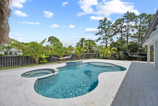 view of pool featuring an in ground hot tub and a patio area